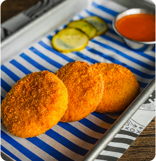 Chorizo & Truffle Mac & Cheese Bites - with buffalo hot sauce.