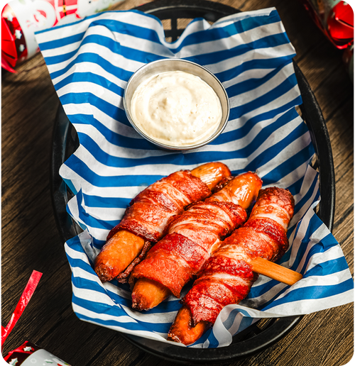 PIGS IN BLANKETS - Pick your festive sauce: Chicken gravy, sage & onion mayo or red wine & shallot mayo.
